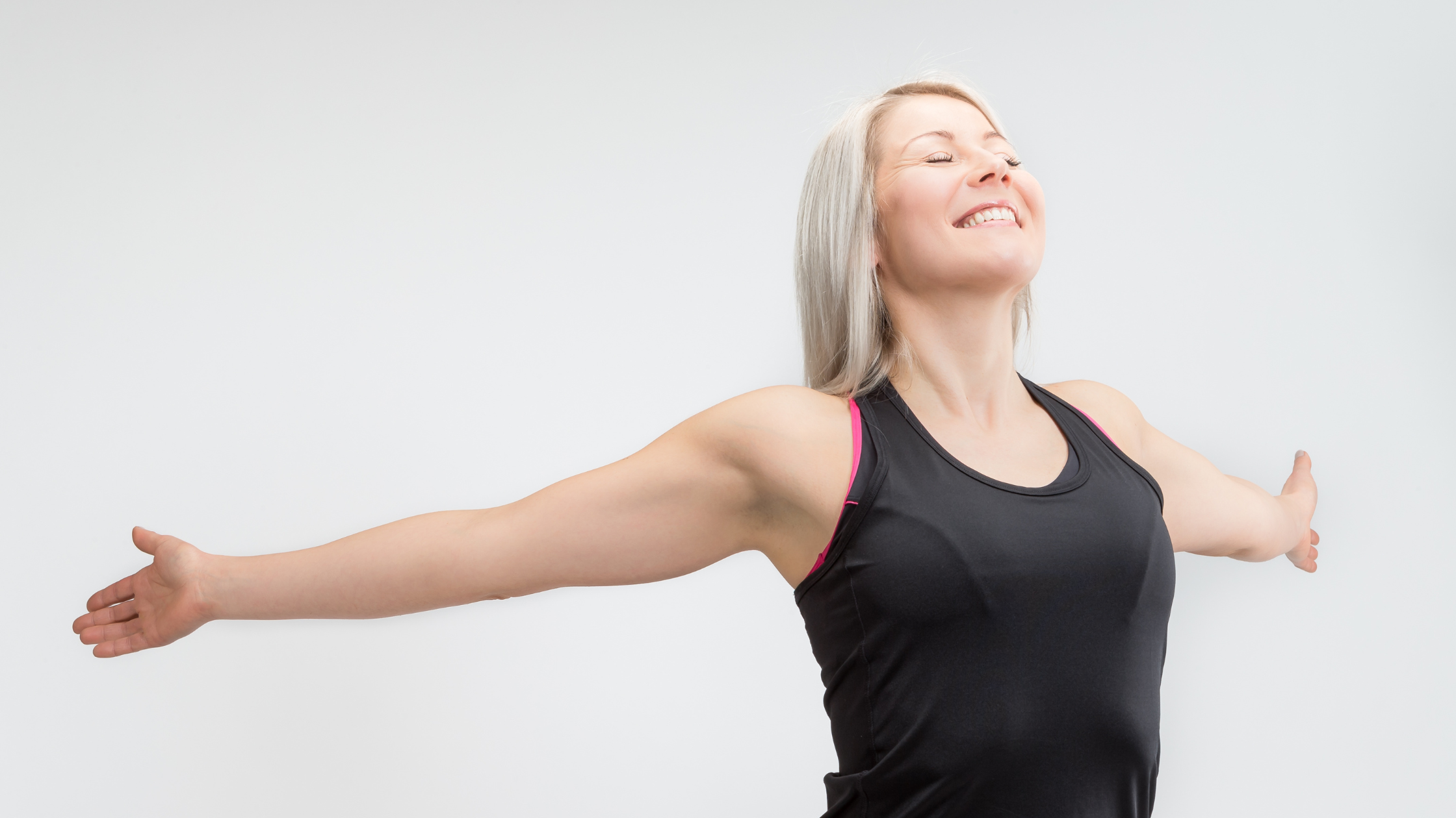 Woman smiling with arms outstretched